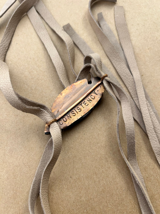 Black and tan petrified wood suede bolo tie